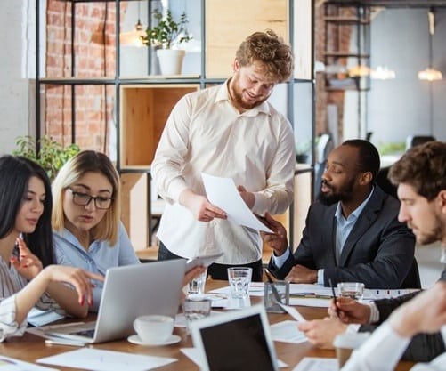 diverse-group-co-workers-having-casual-discussion-office